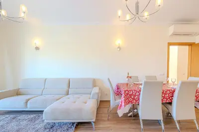 a living room with a couch and a table at Jardins da Marina BI Albufeira Marina in Albufeira