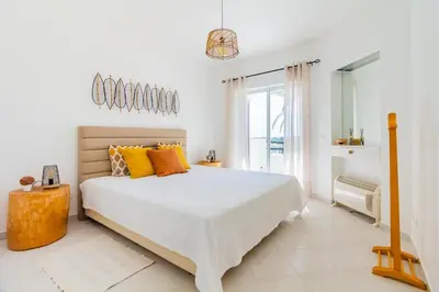 a bedroom with two beds and a window at Happy House in Clube Albufeira in Albufeira