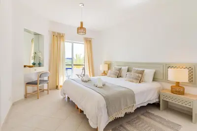 a living room with a blue couch and a table at Albufeira Family Holidays with Pool View in Albufeira