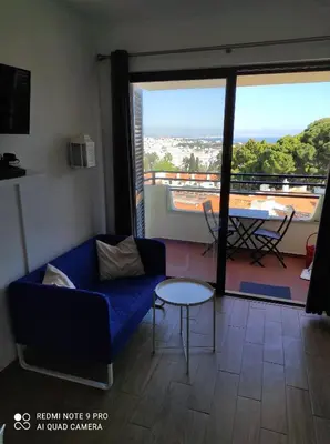 a small kitchen with a table and chairs in a room at Fabulous Sea view Studio near old town Albufeira in Albufeira