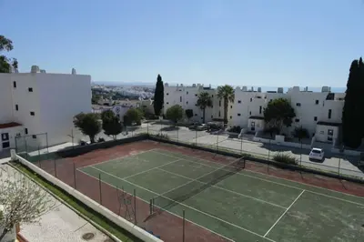 a park with trees and the ocean in the background at Fabulous Sea view Studio near old town Albufeira in Albufeira