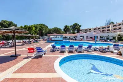 a large swimming pool with chairs and an umbrella at Fabulous Sea view Studio near old town Albufeira in Albufeira