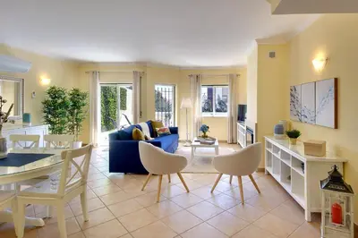 a living room with a blue couch and a table at Eagle Eye Villa in Albufeira