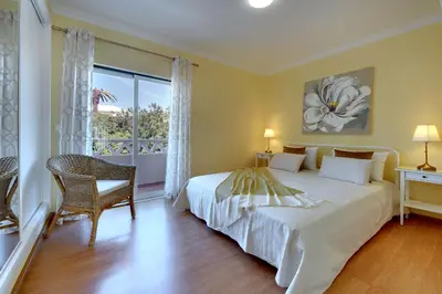 a bedroom with a white bed and a window at Eagle Eye Villa in Albufeira