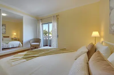 a bedroom with a large white bed and a window at Eagle Eye Villa in Albufeira