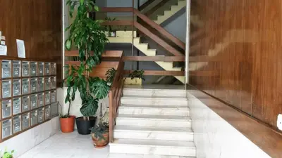 a staircase in a building with potted plants at T1 PonteMira 6 50M PRAIA VISTA MAR in Quarteira