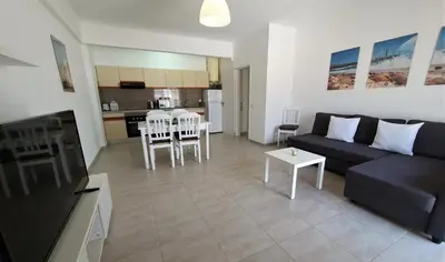 a living room with a couch and a table at T1 Dunas 7 - Aconchegante, Wifi, 150mt Praia in Quarteira