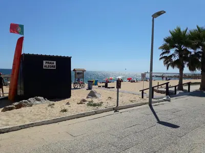 a street light on a beach next to the ocean at Torre 6- Vista Cidade, Aconchegante, 80mt Praia, Wifi in Quarteira