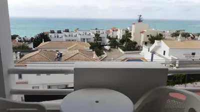 a balcony with a view of buildings and the ocean at Sunset Seaviews Albufeira in Albufeira