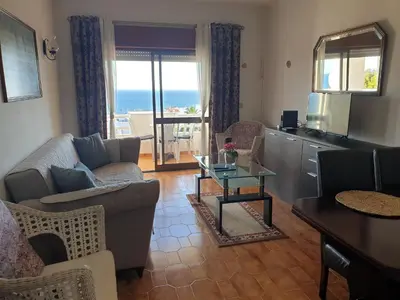 a living room with a couch and a table at Sunset Seaviews Albufeira in Albufeira