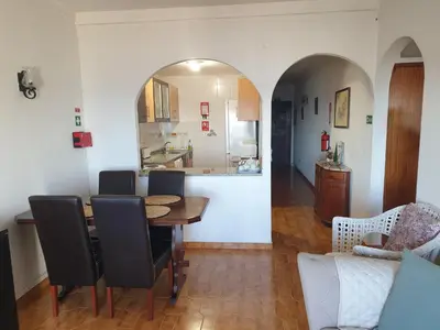a dining room and kitchen with a table and chairs at Sunset Seaviews Albufeira in Albufeira