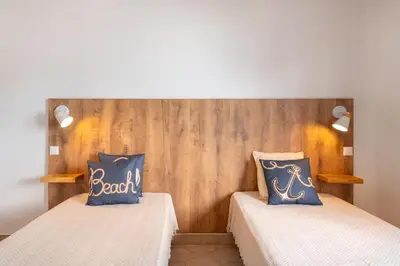 a white building with two balconies on a street at Sunset Azul - Sea View - Free Wifi - By Bedzy in Albufeira