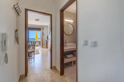 a table with a yellow umbrella on a balcony with the ocean at Sunset Azul - Sea View - Free Wifi - By Bedzy in Albufeira