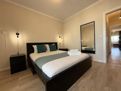 a bedroom with a large bed and a mirror at Go4Portugal - Vilamagna - Luxe Condo with Pool, Airco and Seaview Balcony in Albufeira