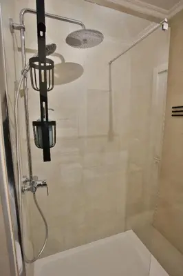 a shower in a bathroom with a glass door at Go4Portugal - Vilamagna - Luxe Condo with Pool, Airco and Seaview Balcony in Albufeira