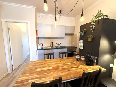 a kitchen with a wooden table in a room at Go4Portugal - Vilamagna - Luxe Condo with Pool, Airco and Seaview Balcony in Albufeira