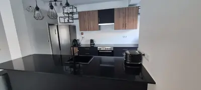 a kitchen with a black counter top and a refrigerator at Large Villa - Private Pool - 6 Bedrooms in Albufeira