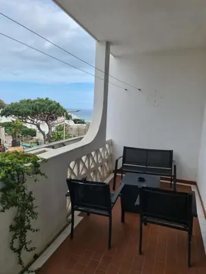 a balcony with two chairs and a table at 1 bedroomed Apartment - Ocean View - Oura - Beach in Albufeira