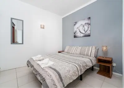 a bedroom with a bed and a table with a lamp at 1 bedroomed Apartment - Ocean View - Oura - Beach in Albufeira
