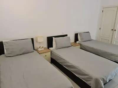 a room with two beds and a table with a lamp at 401 - 2 bedroom Apartment - Oura - Sea View in Albufeira