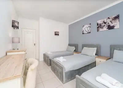 a hotel room with two beds and a desk at 401 - 2 bedroom Apartment - Oura - Sea View in Albufeira