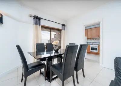 a dining room with a black table and black chairs at 401 - 2 bedroom Apartment - Oura - Sea View in Albufeira