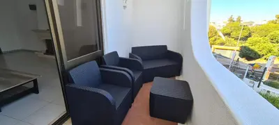 a balcony with two blue chairs and a window at 402 - Oura - 2 Bedroomed Apartment - Sea View in Albufeira
