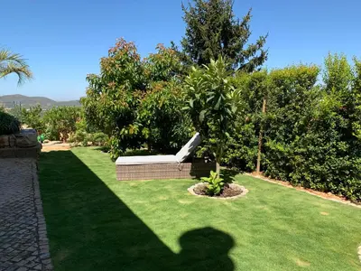 a dining table on a patio with a view at Casa Das Palmeiras in Loulé