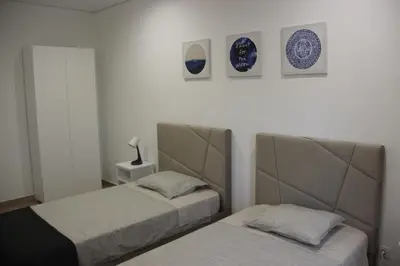 two beds in a room with plates on the wall at Quinta do Sr. Cabrita in Albufeira