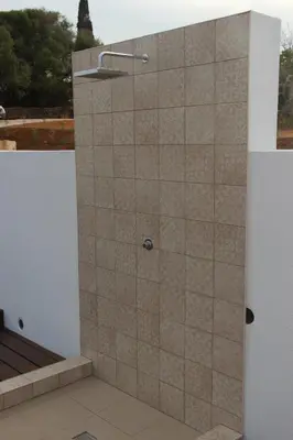 a shower stall with a shower head on a wall at Quinta do Sr. Cabrita in Albufeira