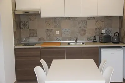 a kitchen with a sink and a table and chairs at Quinta do Sr. Cabrita in Albufeira