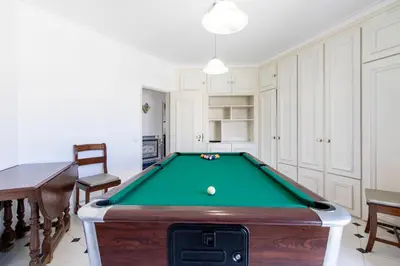 a living room with a pool table in it at Villa Brisa do Mar in Galé