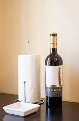 a bottle of wine sitting next to a roll of toilet paper at Histórical City Center Penthouse Albufeira in Albufeira