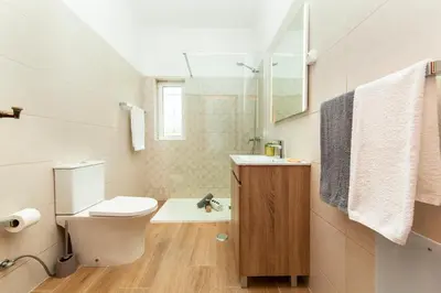 a bathroom with a toilet and a sink and a shower at Villa Palms by Algarve Vacation in Albufeira