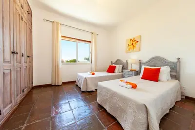 a bedroom with two beds and a window at Villa Palms by Algarve Vacation in Albufeira