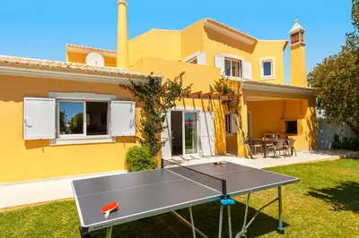 a ping pong table in front of a house at Villa Palms by Algarve Vacation in Albufeira