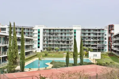 an apartment complex with a basketball court and trees at Residences Golf Club Apartment in Quarteira