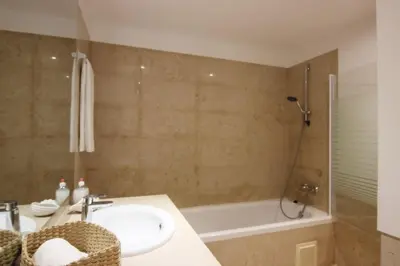 a bathroom with a sink and a bath tub at Residences Golf Club Apartment in Quarteira