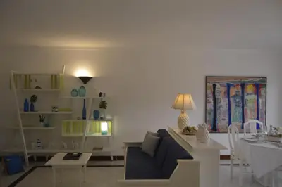a living room with a couch and a table at Apartamento próximo da Marina Vilamoura c/piscina e estacionamento in Vilamoura