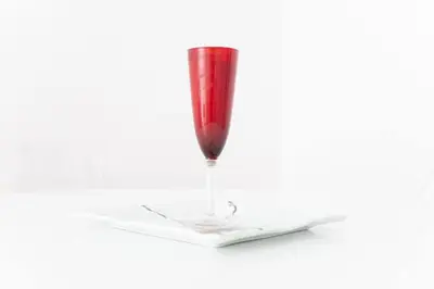 a red glass sitting on top of a book at Old Charming Faro Apartment in Faro