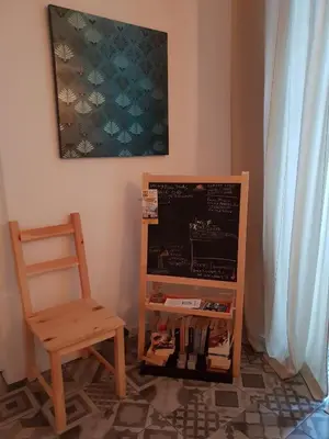 a chair sitting next to a chalkboard next to a table at Old Charming Faro Apartment in Faro
