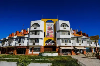 a large white and yellow building with a sign on it at AL-Dream Oura Estrela Apartments - CC in Albufeira