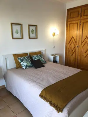 a bedroom with a large bed with two pillows at AL-Dream Oura Estrela Apartments - CC in Albufeira