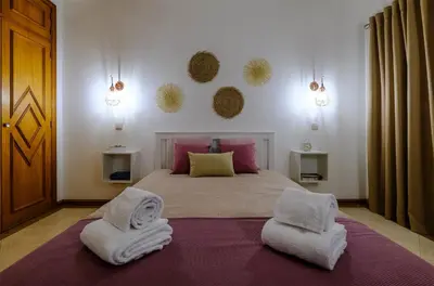 a bedroom with a bed with two towels on it at AL-Dream Oura Estrela Apartments - CD in Albufeira
