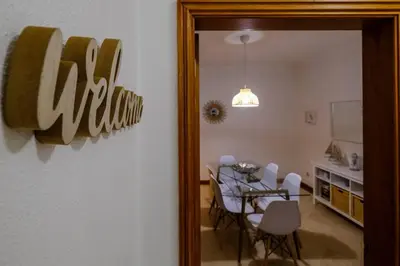 a dining room with a table and chairs and a mirror at AL-Dream Oura Estrela Apartments - CD in Albufeira