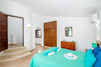 a bedroom with a blue bed with a blue blanket at Villa Ushuaia by Algarve Vacation in Guia