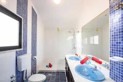 a blue and white bathroom with a toilet and a sink at Villa Ushuaia by Algarve Vacation in Guia