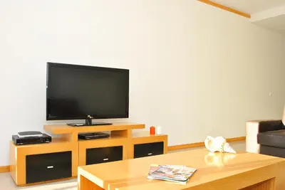 a living room with a flat screen tv and a coffee table at Townhouse Mar 2 by Algarve Vacation in Albufeira