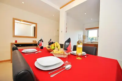 a red dining room table with a red table cloth at Townhouse Mar 2 by Algarve Vacation in Albufeira