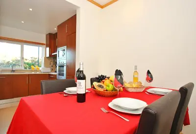 a table with a red table cloth and wine bottles at Townhouse Mar 2 by Algarve Vacation in Albufeira